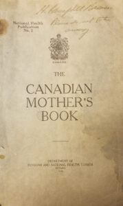 A beige page with slight rust/water stains along the edges. The words "The Canadian Mother's Book" are listed in the middle.