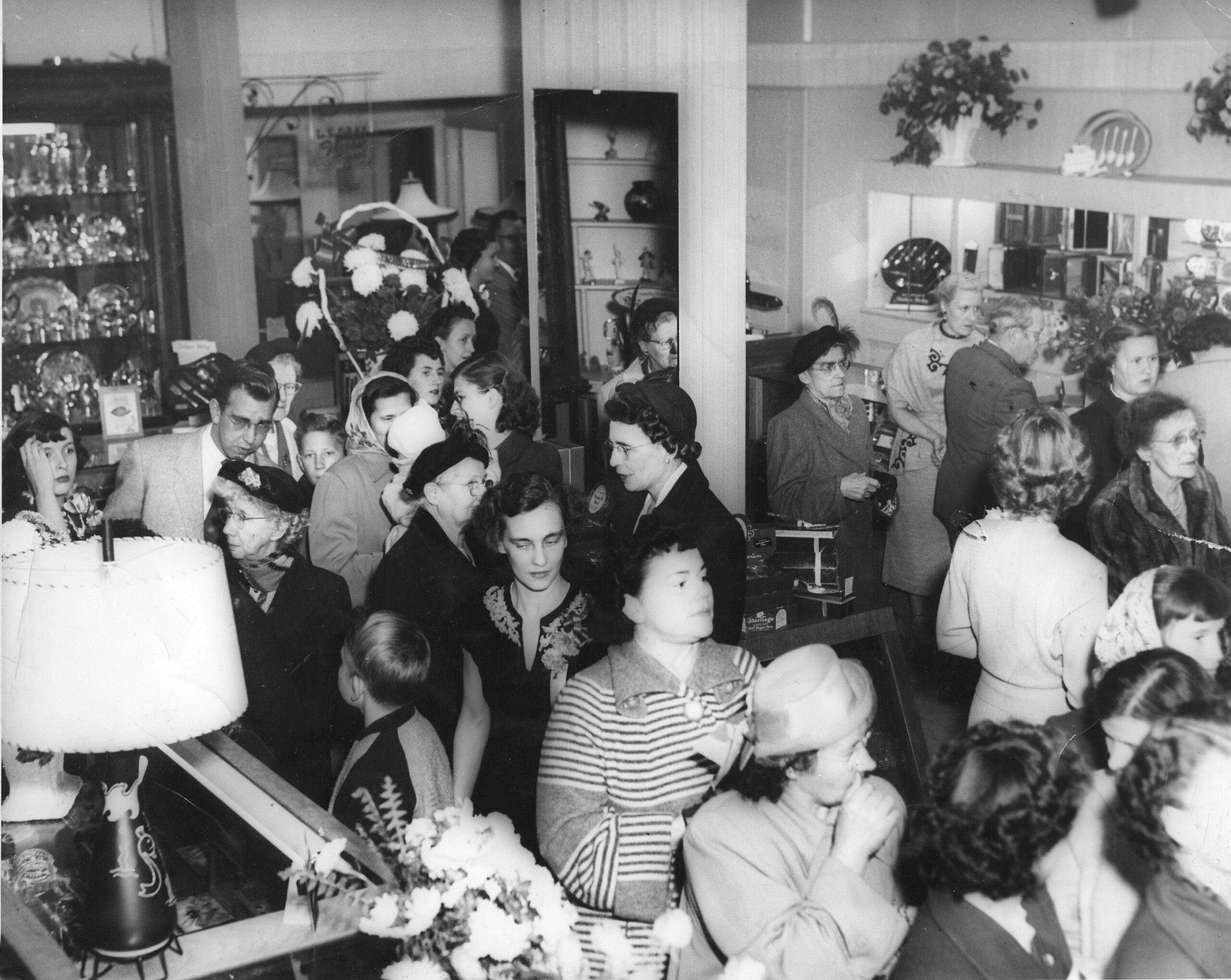 A crowd of people inside a shop.