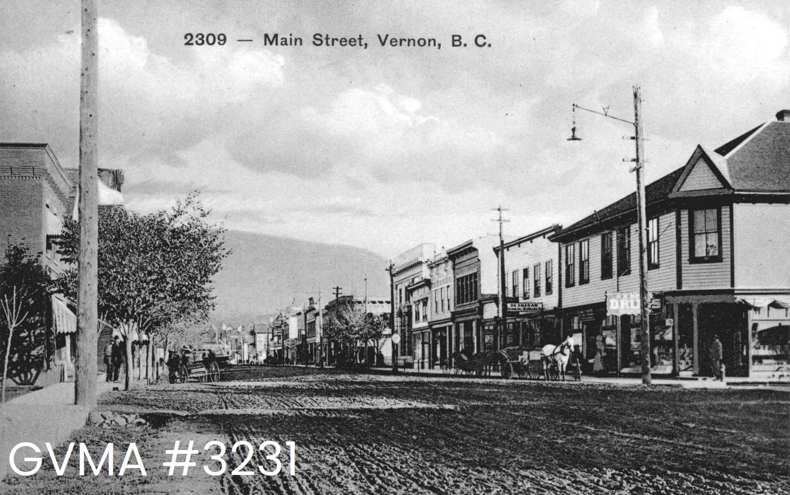 A black-and-white image of a muddy streetscape, with buildings lining the side. Along the top of the image is printed the text "2309 Main Street, Vernon, B.C."