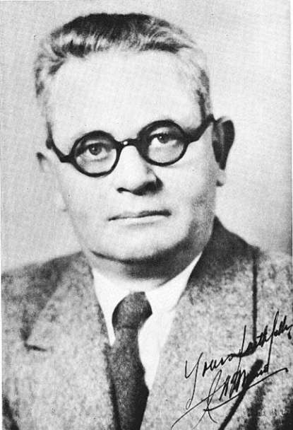 A person wearing glasses and a suit.