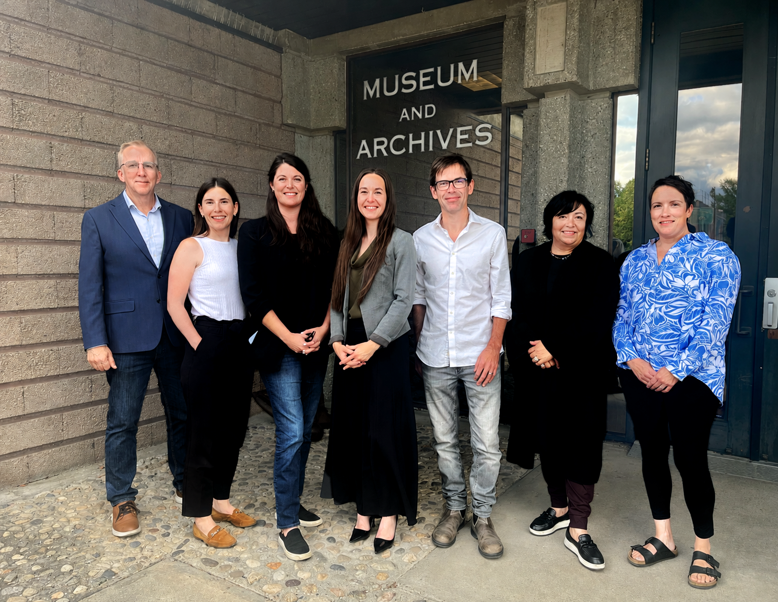 The seven members of the 2026–2027 GVMA Board of Directors standing in front of the Museum and Archives entrance.